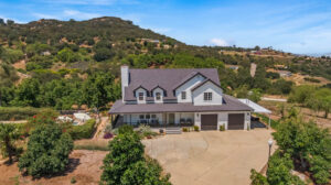 farmhouse surrounded by avocado trees